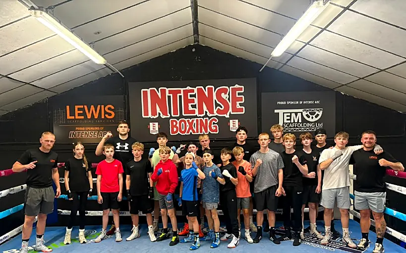 Junior boxers with coaches in the ring at Intense Boxing Plymouth